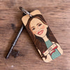 Keychain with a portrait of a woman on a wooden surface